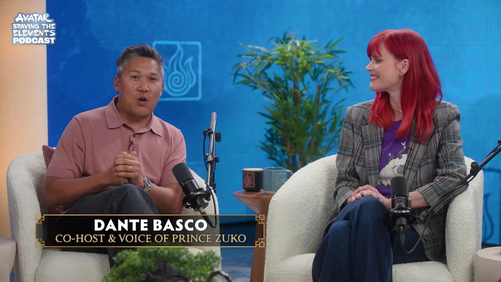Dante Basco, the voice of Prince Zuko, and Janet Varney, the voice of Korra, seated together on the Avatar: Braving the Elements podcast set. Image: Avatar Legends