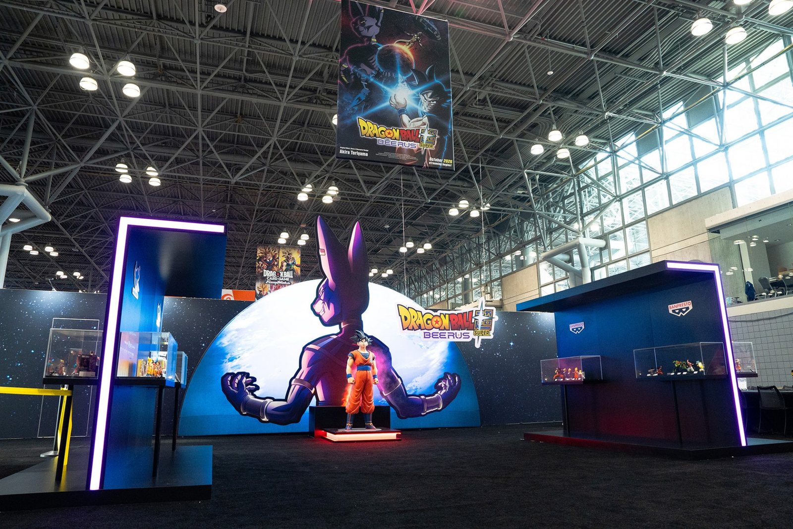 The Dragon Ball Super: Beerus booth at New York Comic Con, with a large Beerus statue and a Goku figure under the key visual banner. Image: Toei Animation, ©BIRD STUDIO/SHUEISHA, TOEI ANIMATION