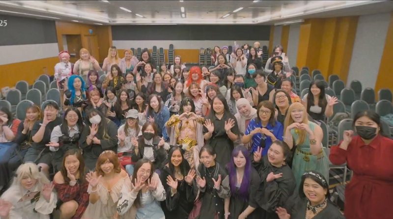 Fans wave and make heart shapes for the camera in a meeting room at the Suntec convention centre during AFA Singapore 2025. Image: Anime Festival Asia