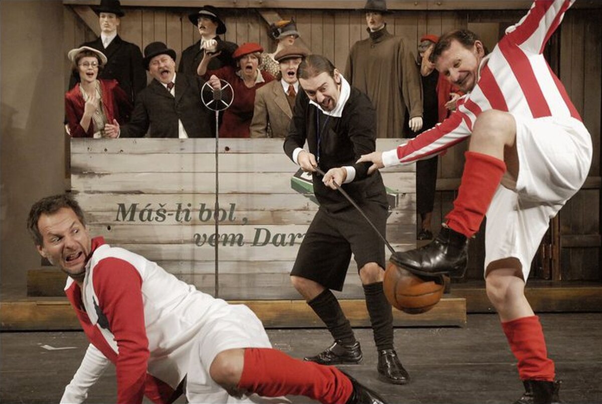 A scene from the musical comedy Muži v offsidu at the Municipal Theatre in Mladá Boleslav, with Ota Jirák in the back row. Photo: Martin Špelda, Městské divadlo Mladá Boleslav, CC BY-SA 3.0