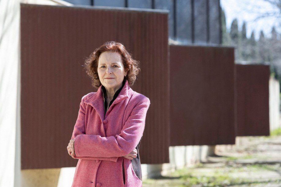 Marta Angelat in a pink coat, arms folded, outdoors. Image: AISGE, photo by Marc Llibre